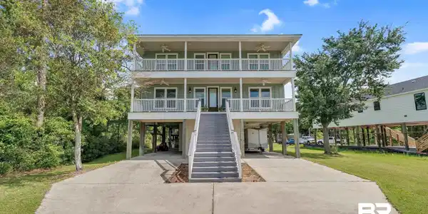 Image 2: View of front of property featuring a carport, ceiling fan, covered porch, driveway, and stairs