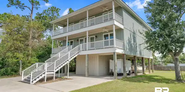Image 3: View of front of house featuring a ceiling fan, a balcony, a carport, and stairway
