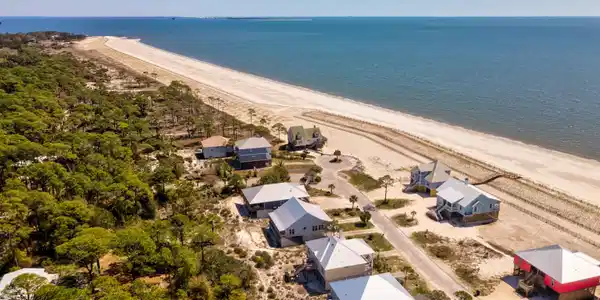 Image 3: Aerial perspective of suburban area with waterfront with a beach