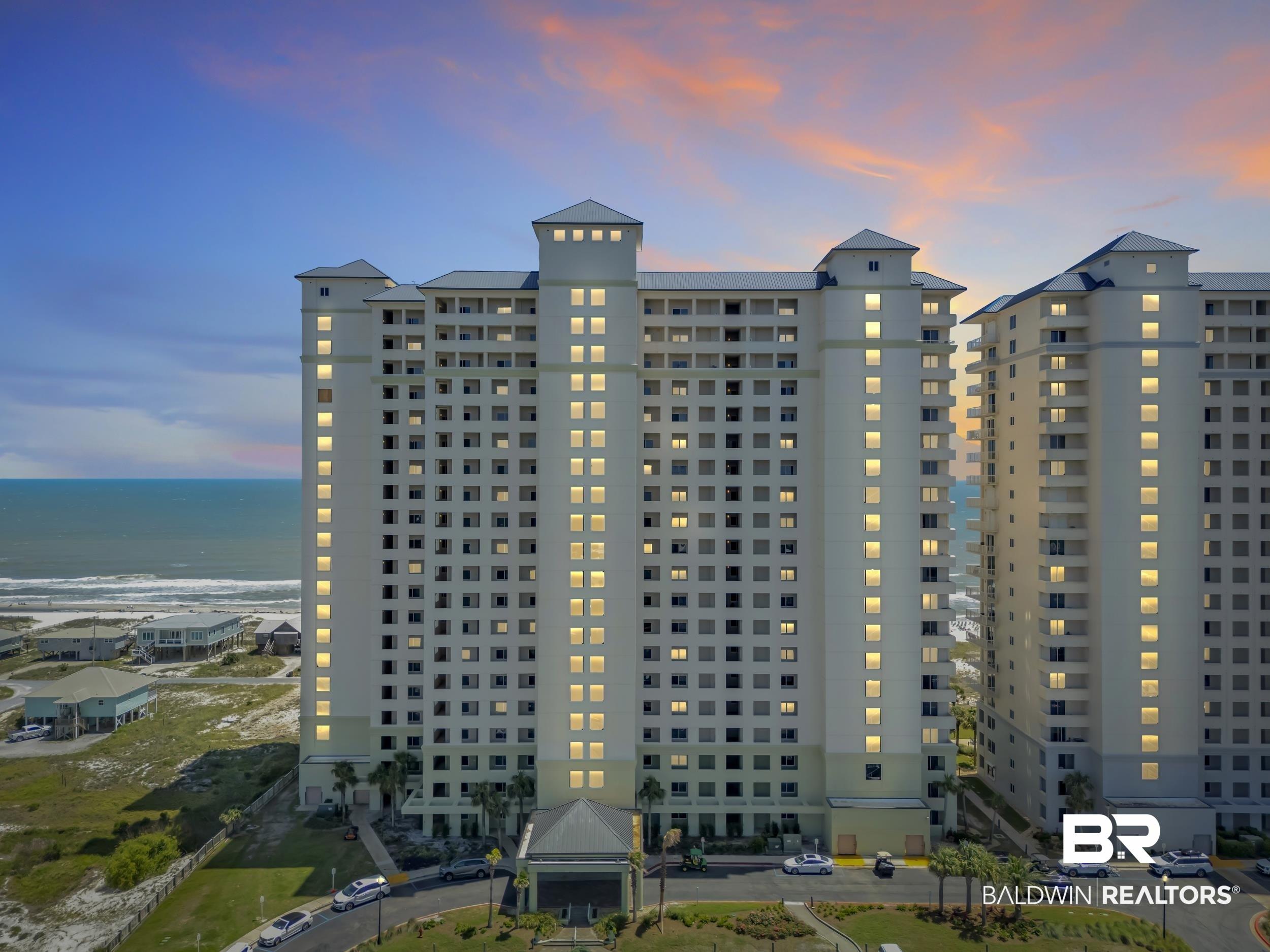 Image 1: Multi-story residential building with a light-colored facade