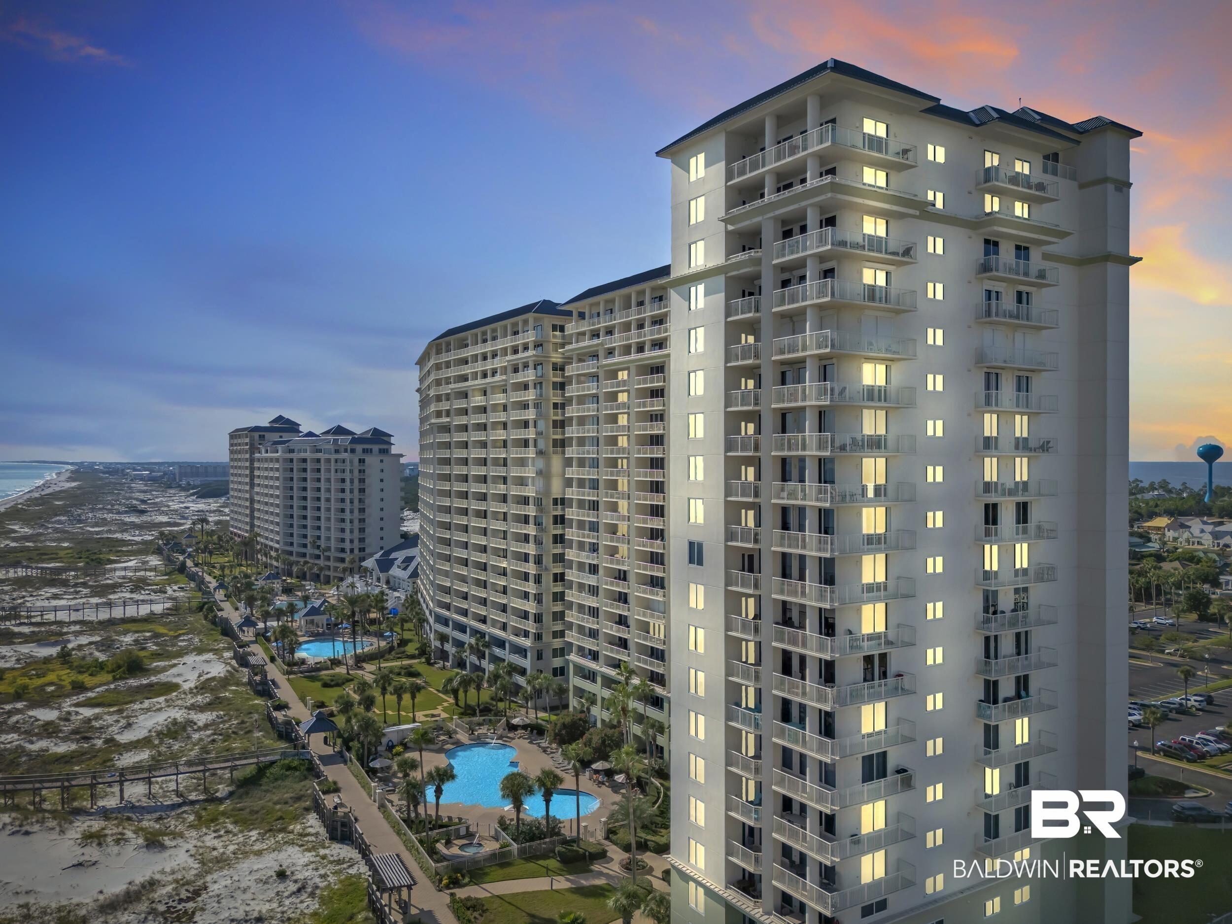 Image 3: High-rise architectural design featuring multiple private balconies, expansive windows, and a landscaped property with two outdoor swimming pools
