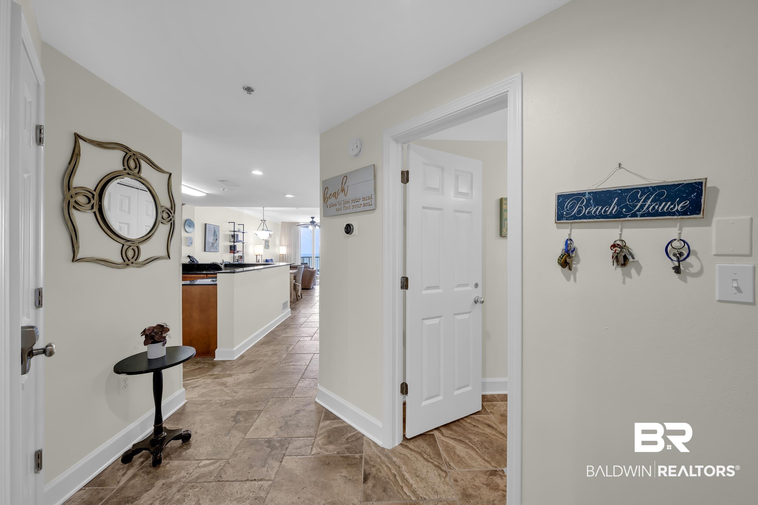 Image 4: Entryway featuring large format tile flooring, neutral wall tones, white trim, and recessed lighting