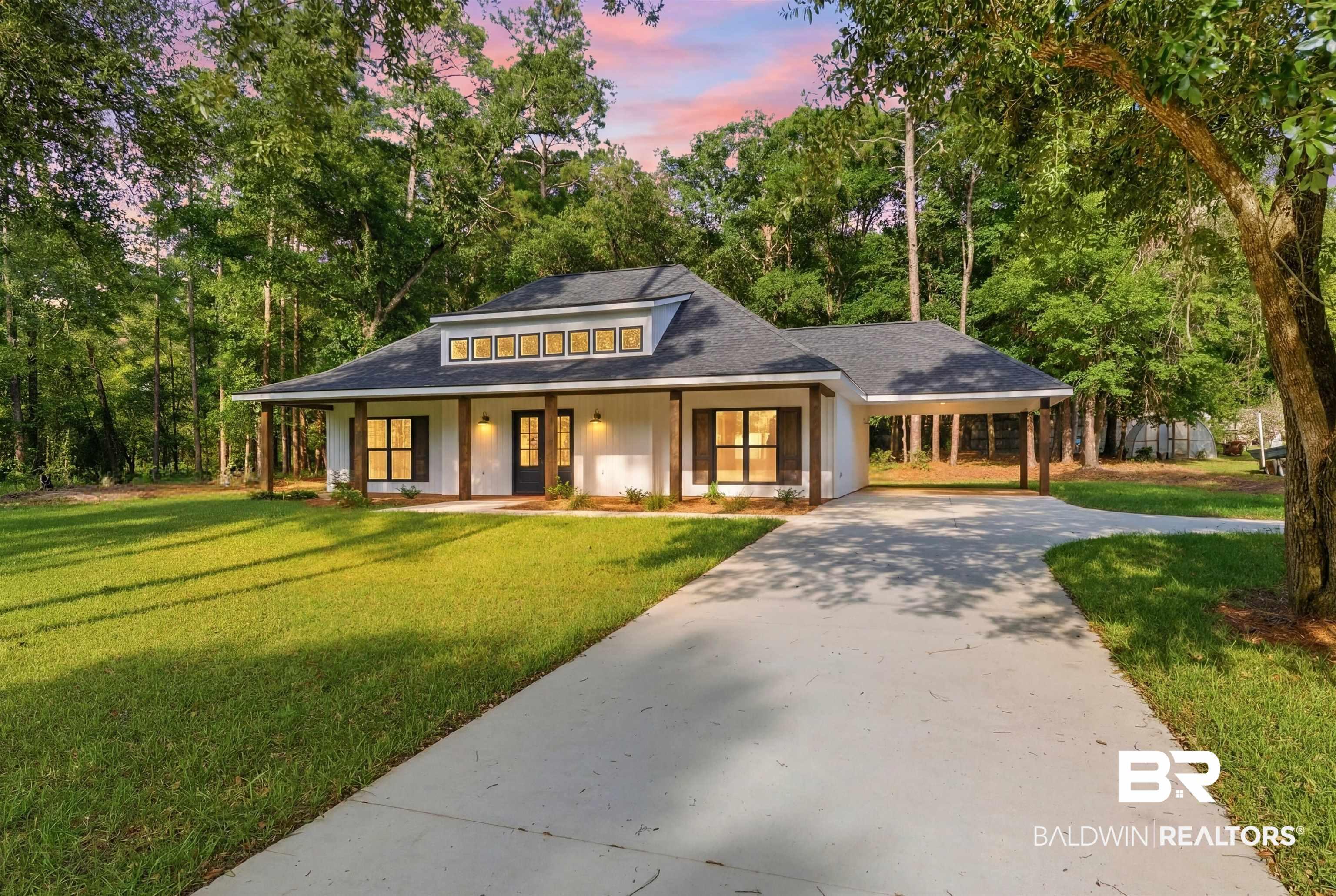 Image 1: Contemporary farmhouse exterior featuring white siding, dark trim, a dark asphalt shingle roof, wood support columns, and a dormer with multiple windows