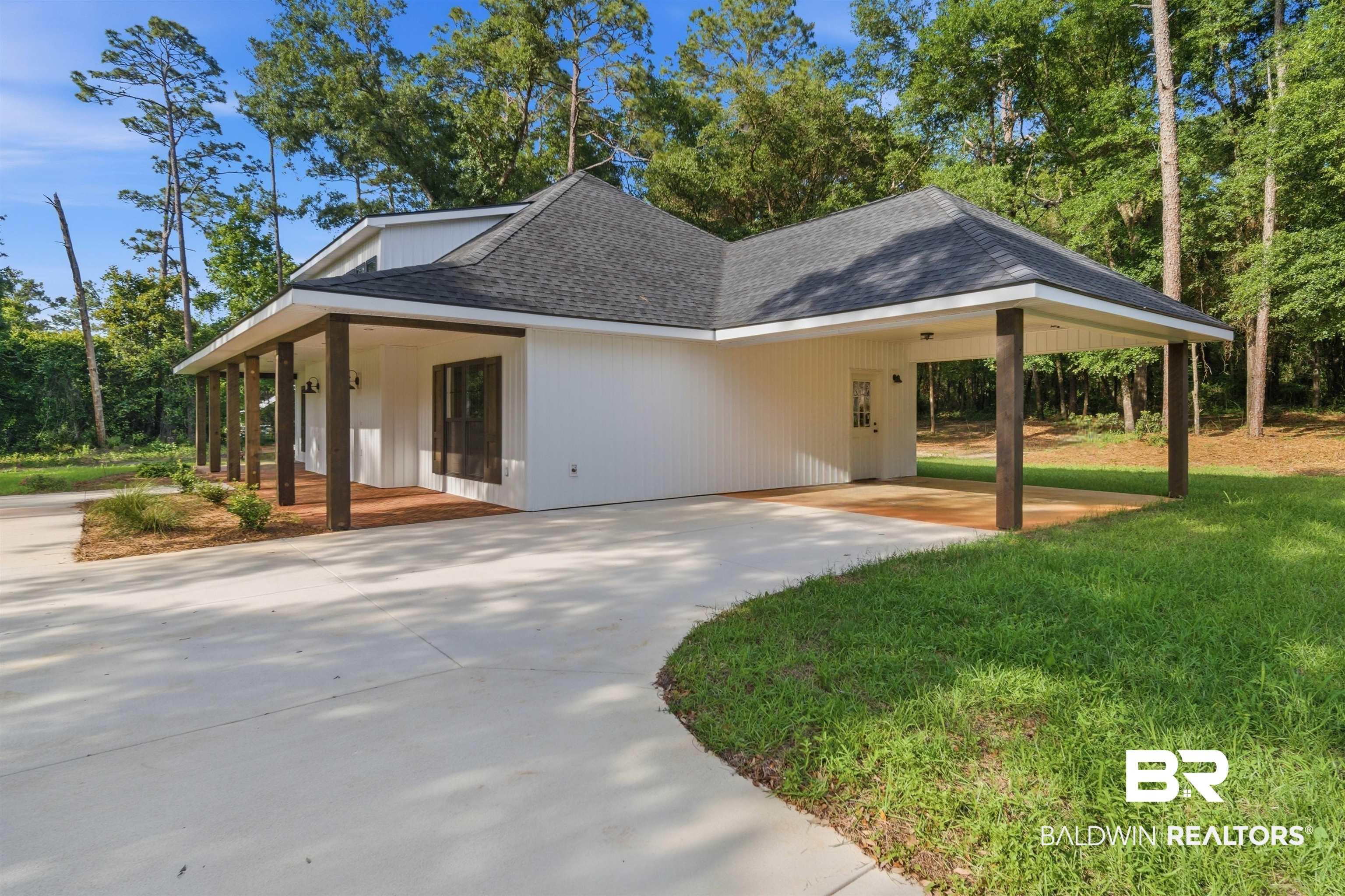 Image 3: White siding exterior with a dark shingle roof