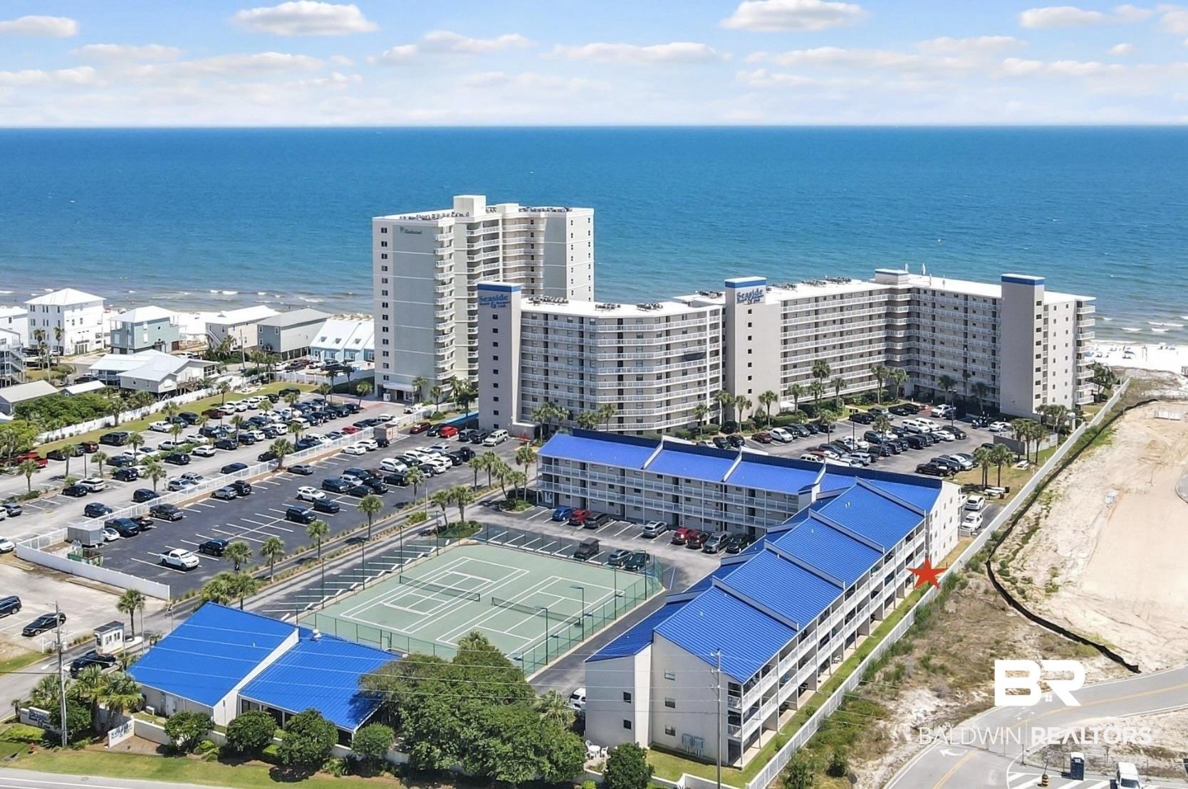 Image 2: Drone / aerial view of apartment complex and a large body of water