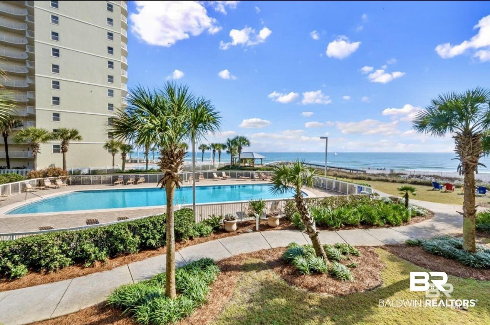 Image 4: Community pool with a water view