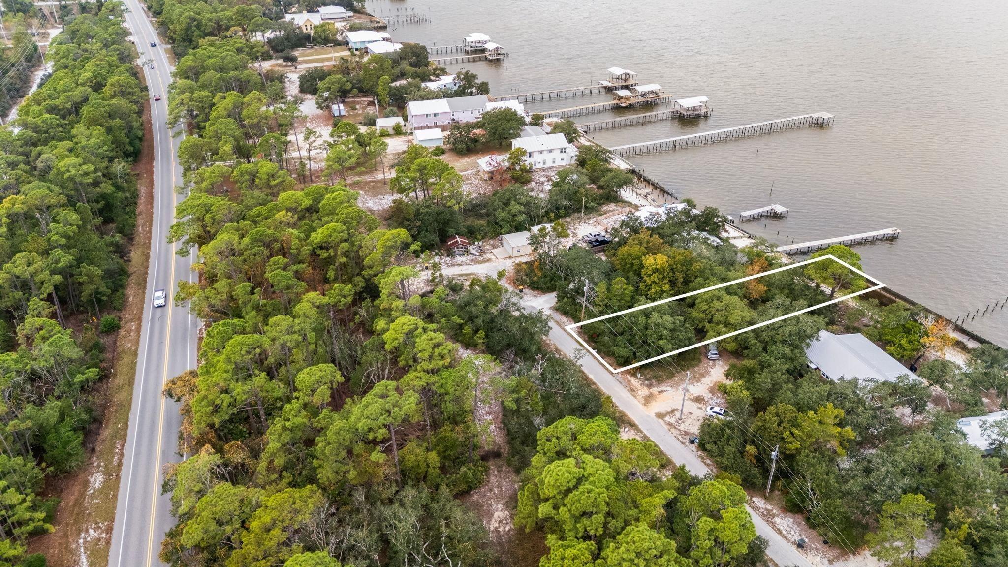 Image 2: View of property location with property boundaries highlighted and a large body of water