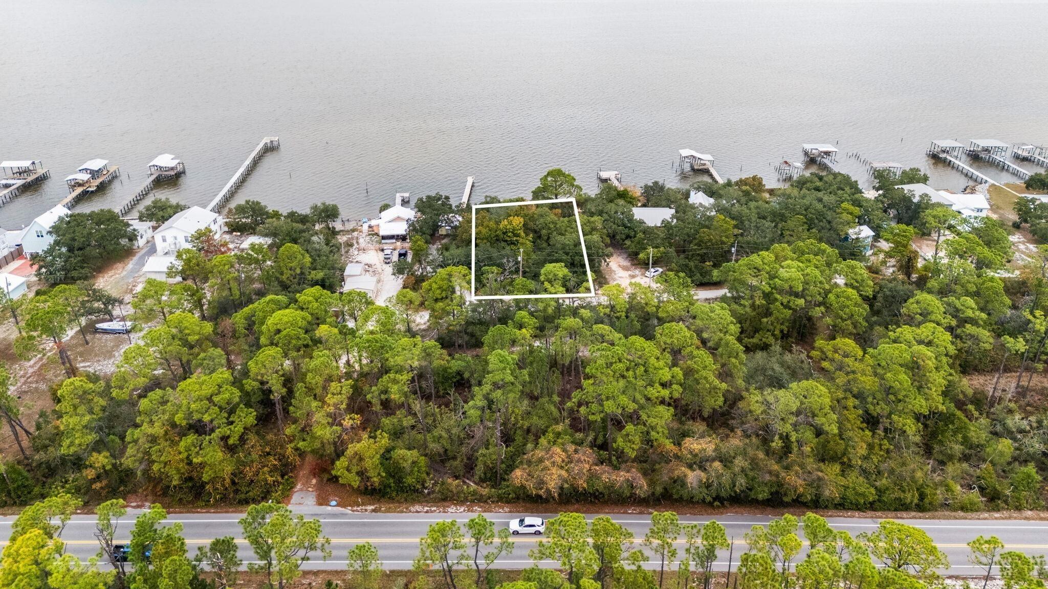 Image 3: Aerial overview of property's location with property boundaries highlighted and a large body of water
