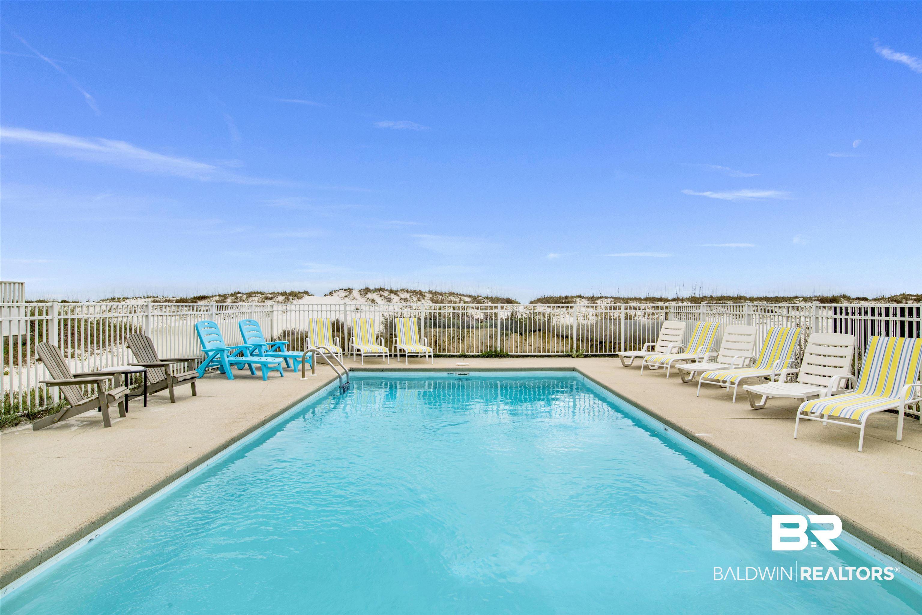 Image 2: Community pool featuring a patio