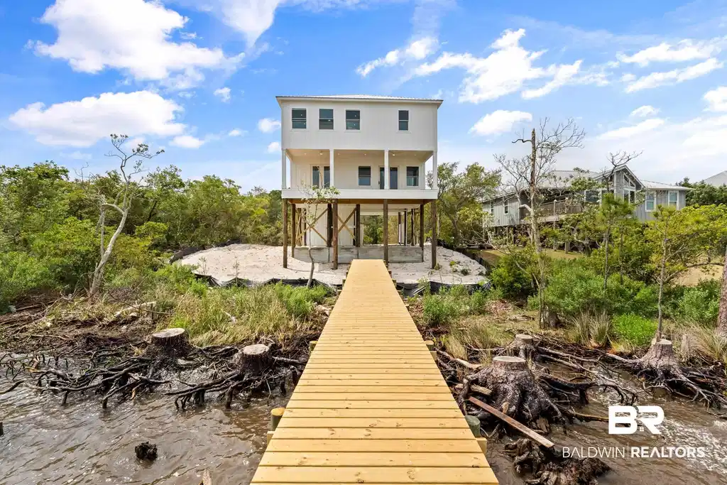 Image 1: Elevated coastal residence featuring a new wood dock