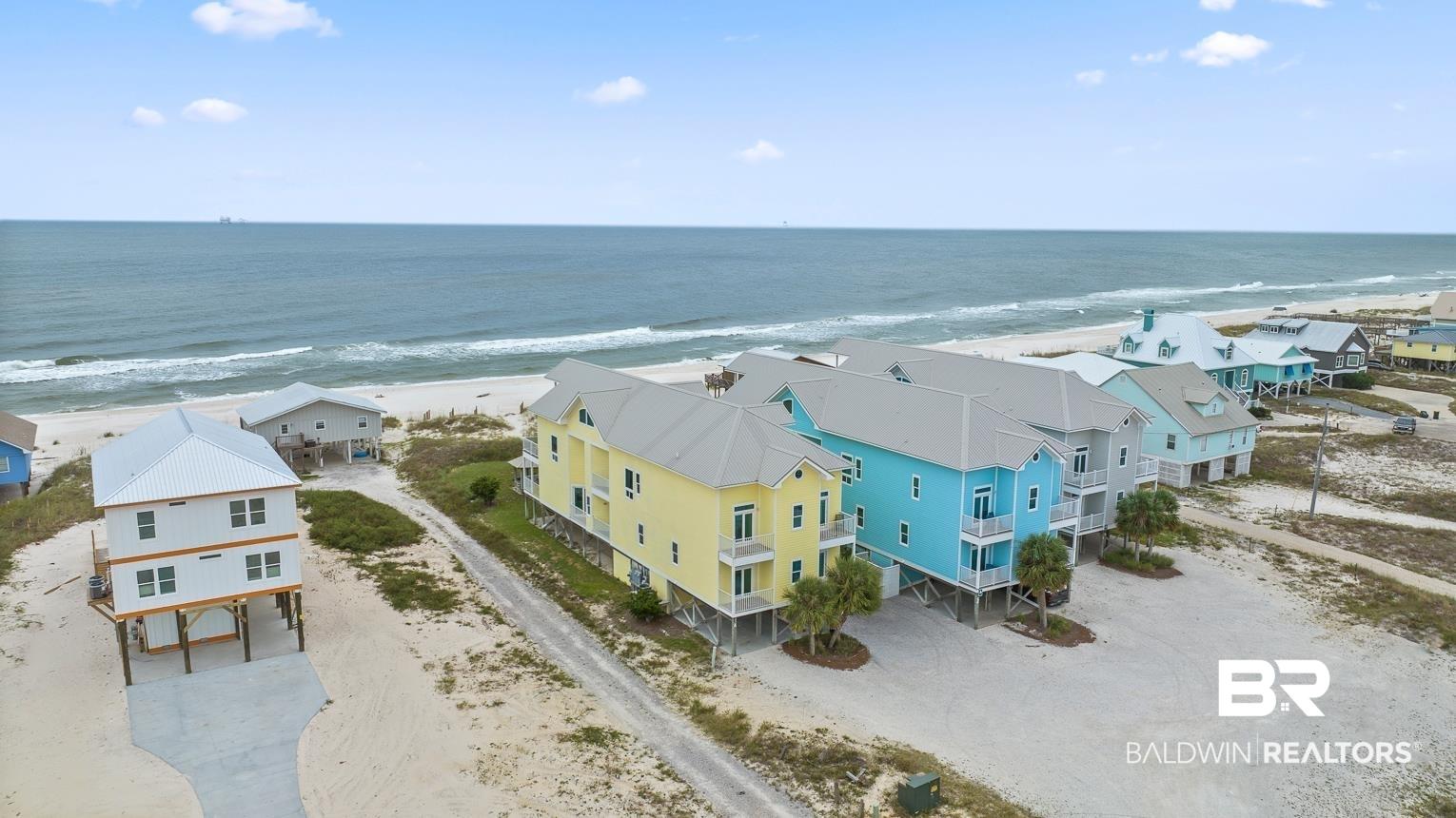 Image 3: Aerial view of residential area featuring expansive beach