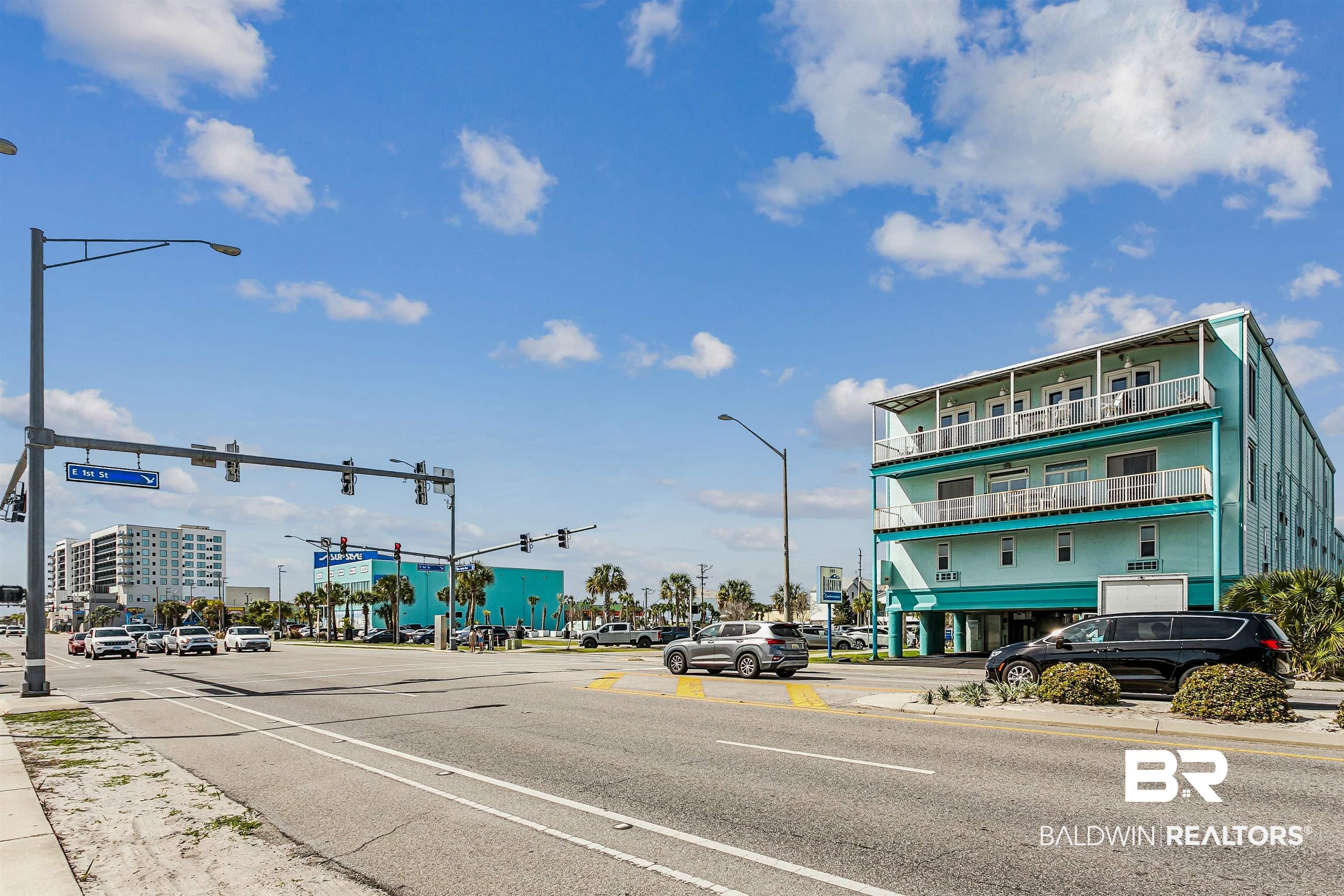 Image 2: View of asphalt street featuring street lighting, sidewalks, and curbs