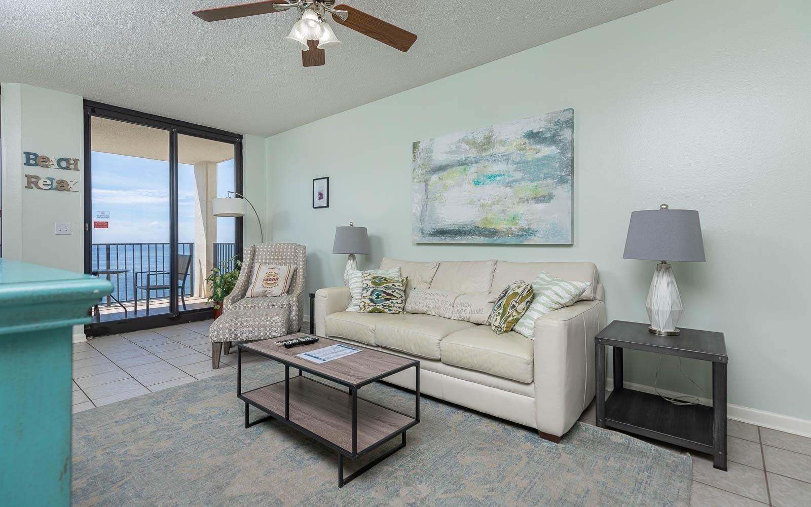 Image 2: Living room with baseboards, a textured ceiling, floor to ceiling windows, and tile patterned flooring