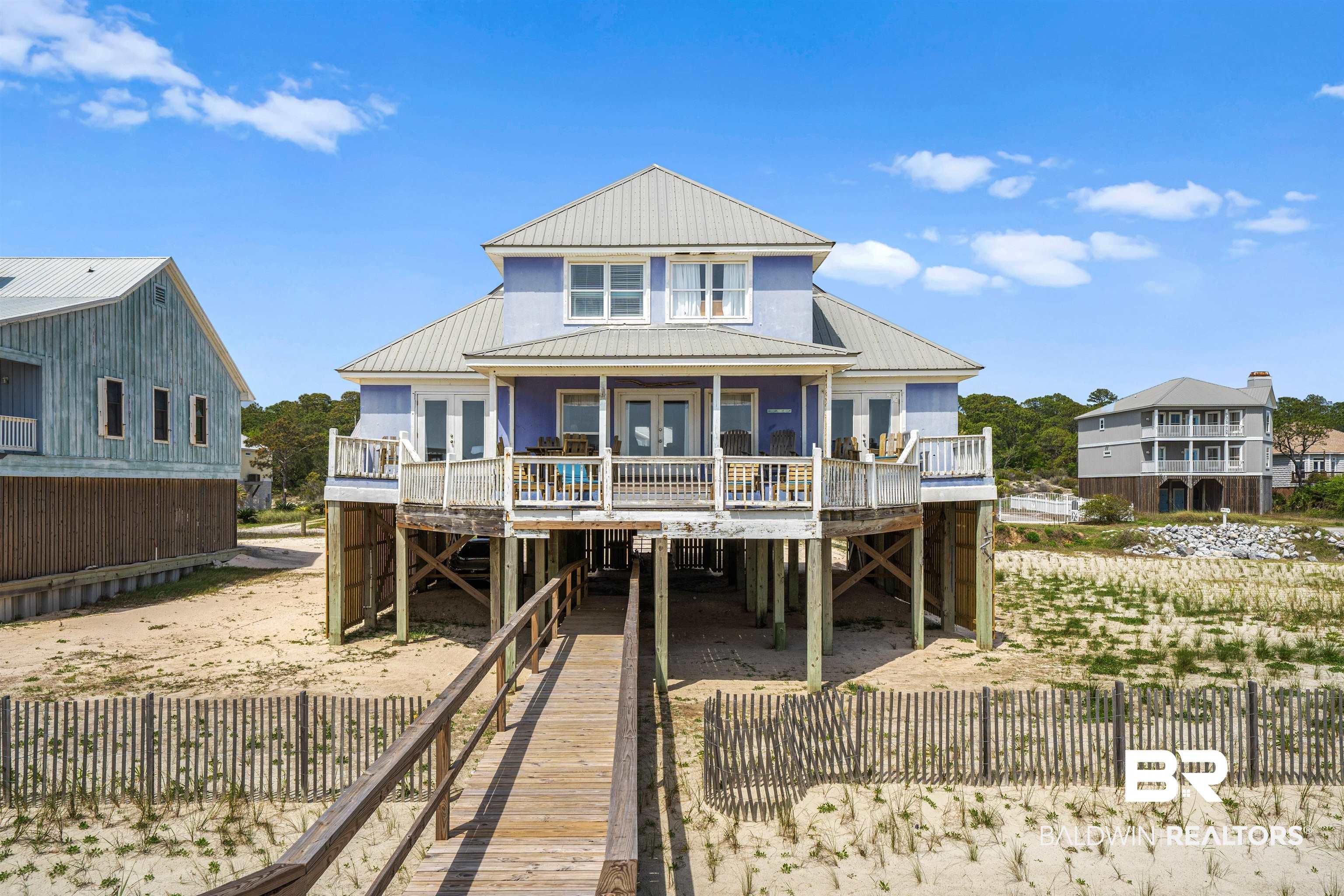 Image 2: Back of house with a metal roof, a deck, and a carport
