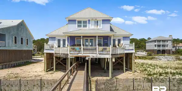 Image 2: Back of house with a metal roof, a deck, and a carport
