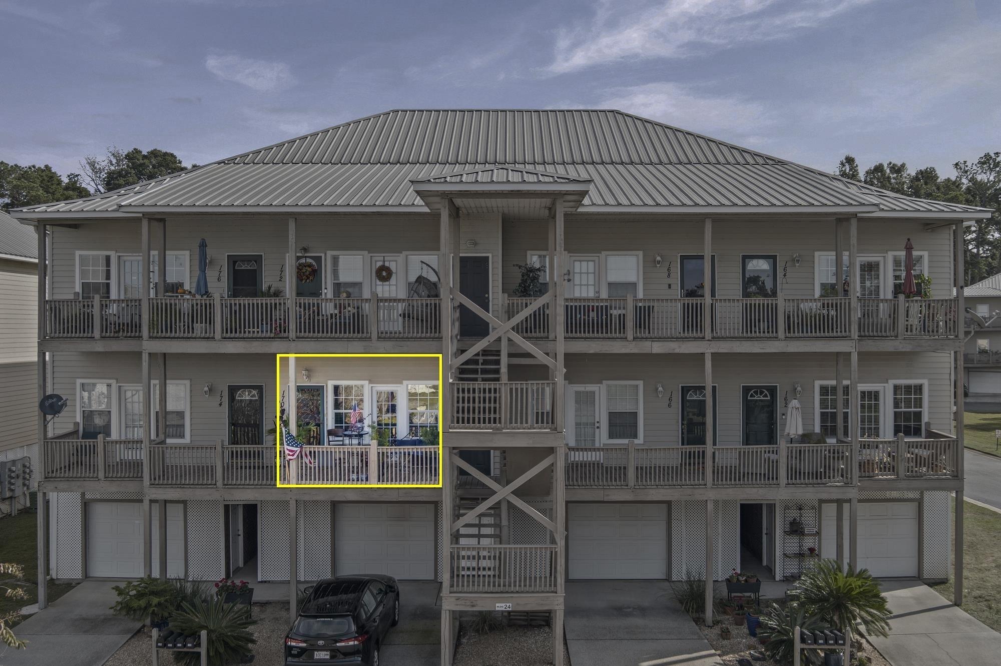 Image 1: View of apartment building / complex featuring driveway and a garage