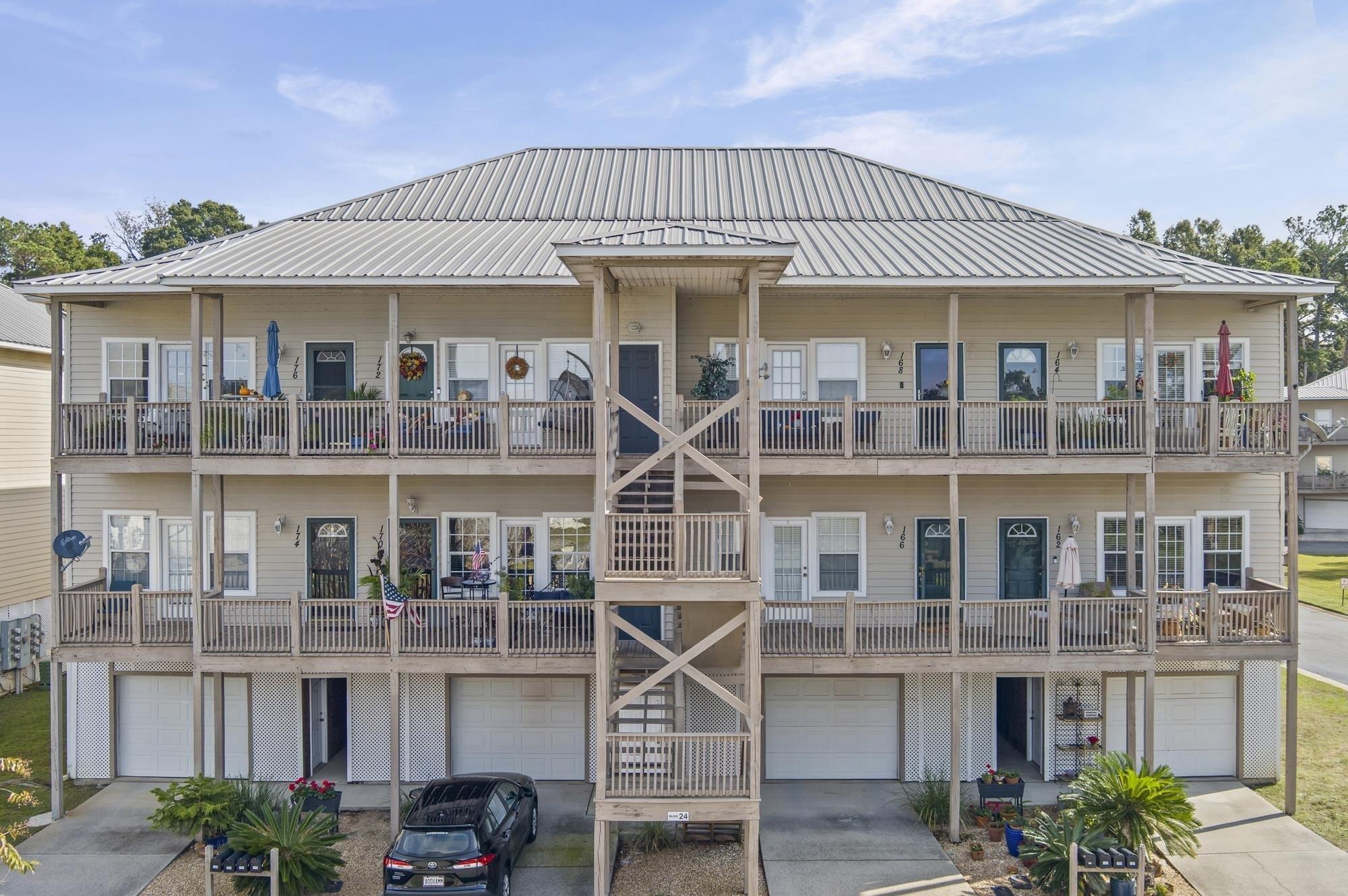 Image 3: View of apartment building / complex with driveway and an attached garage