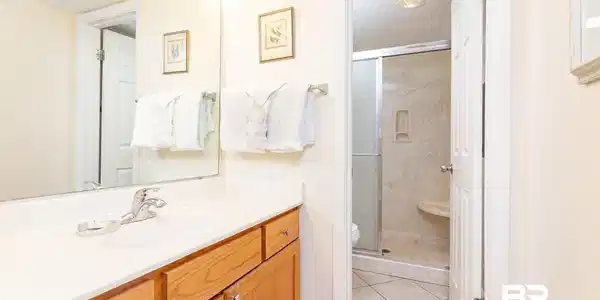 Image 4: Full bathroom featuring vanity, a stall shower, light tile patterned floors, and a textured ceiling