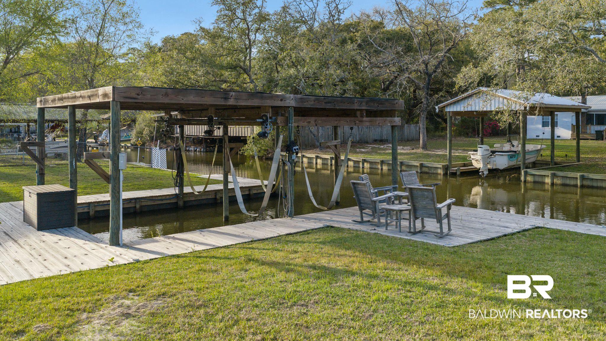 Image 3: Dock area featuring a water view and a yard