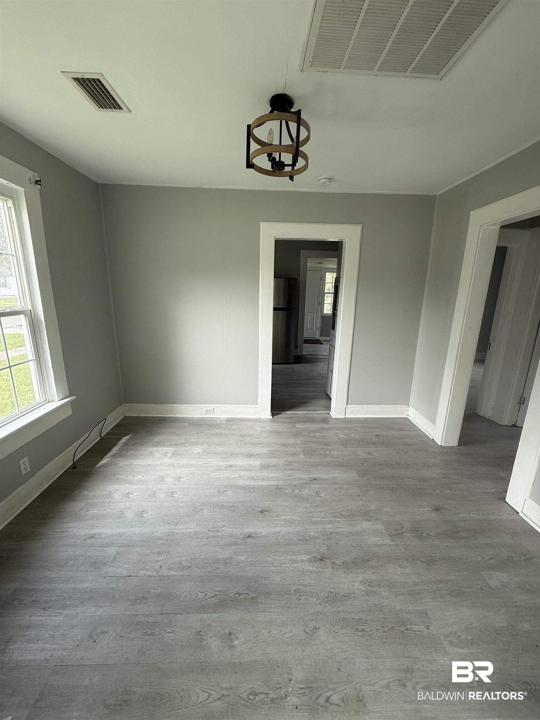 Image 3: Unfurnished dining area featuring light wood-style floors