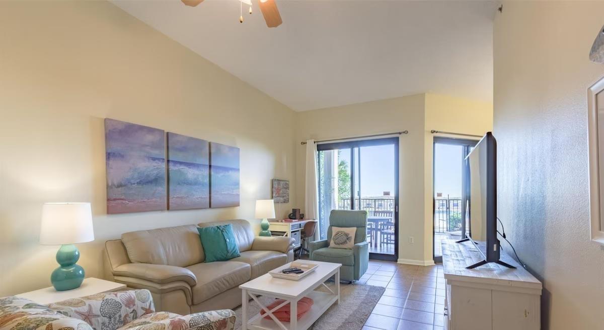 Image 3: Living room with tile patterned flooring and a ceiling fan