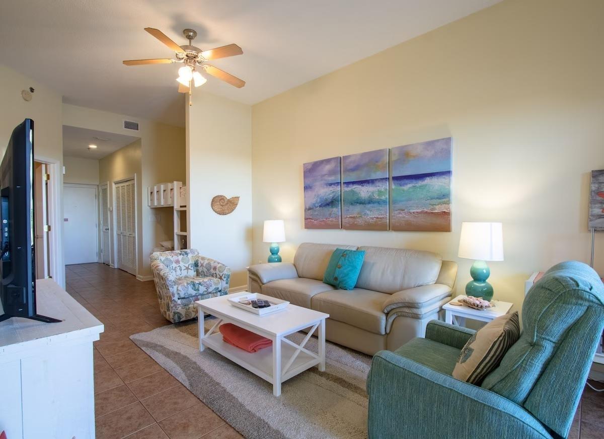 Image 4: Tiled living area featuring a ceiling fan