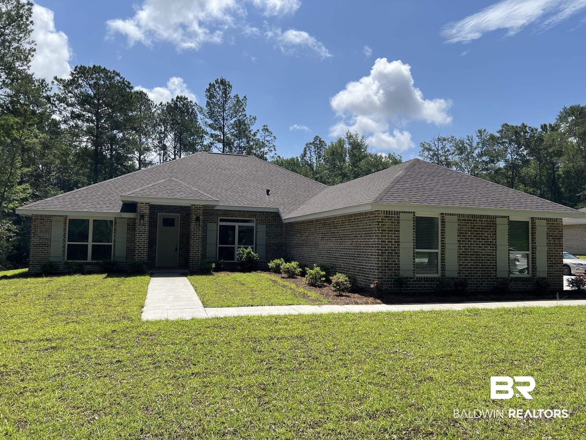 Image 1: Brick exterior with a dark shingle roof, featuring light-colored window shutters, a concrete walkway, and a landscaped front yard