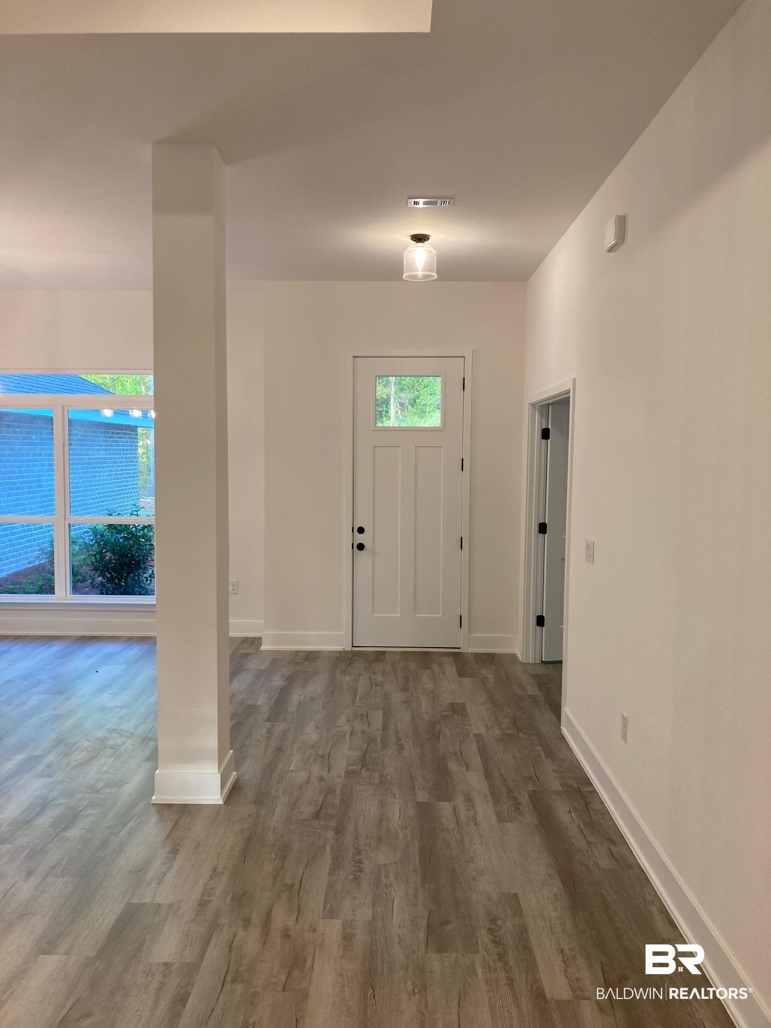 Image 4: Entrance foyer with dark wood-type flooring and healthy amount of natural light