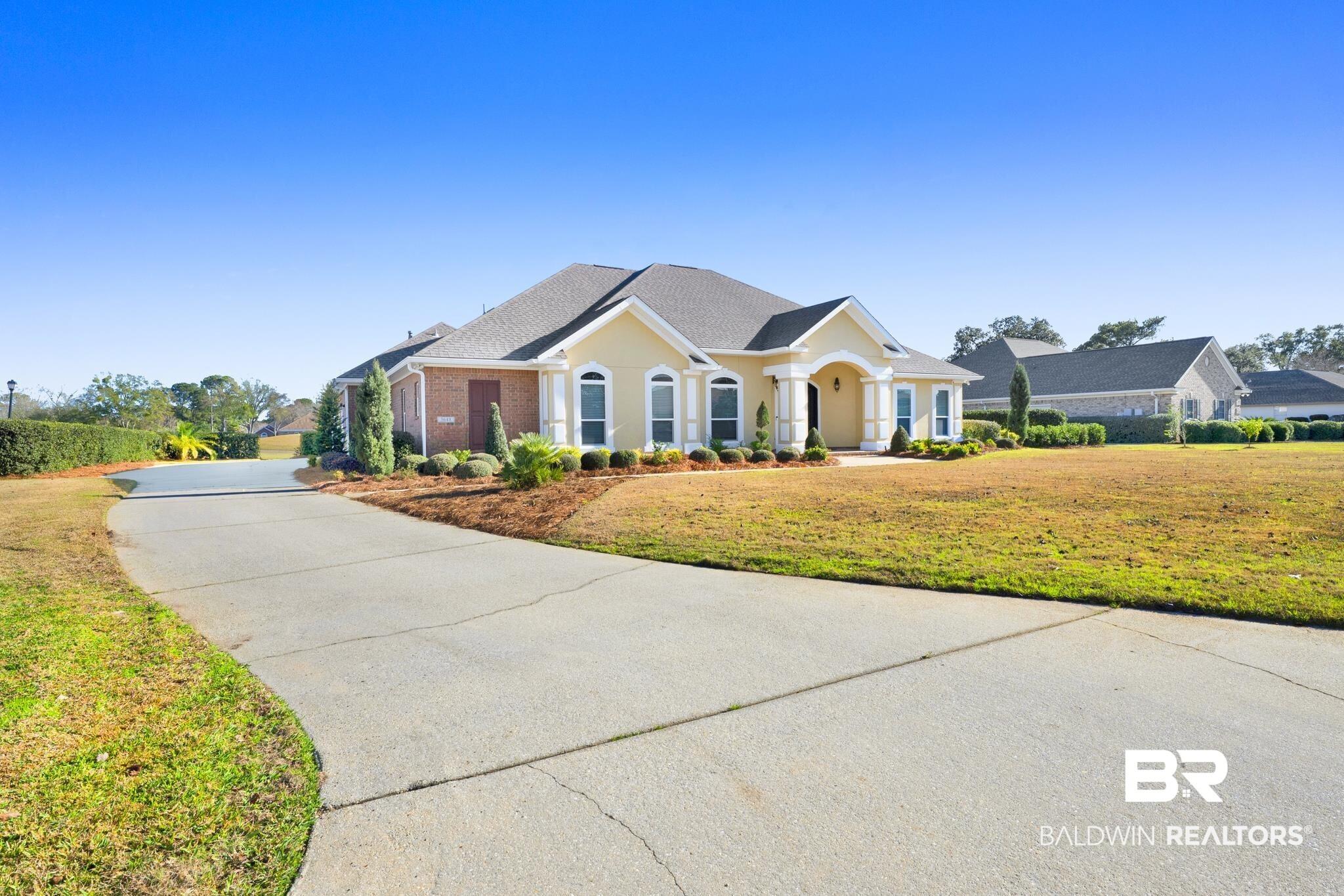 Image 2: Single story home with a front yard, brick siding, a shingled roof, and driveway