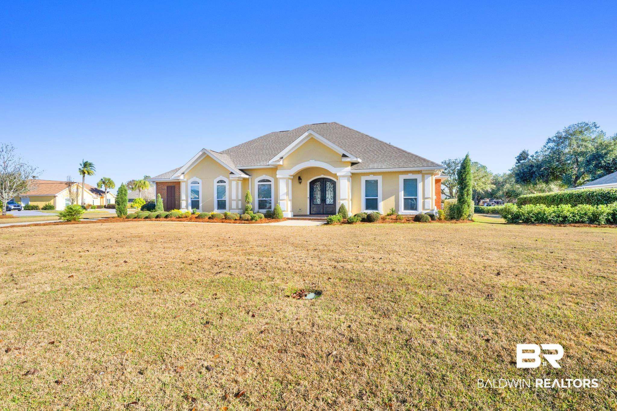 Image 3: Ranch-style home featuring a front lawn and stucco siding