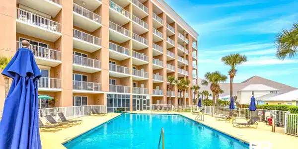 Image 2: Community pool featuring a patio area