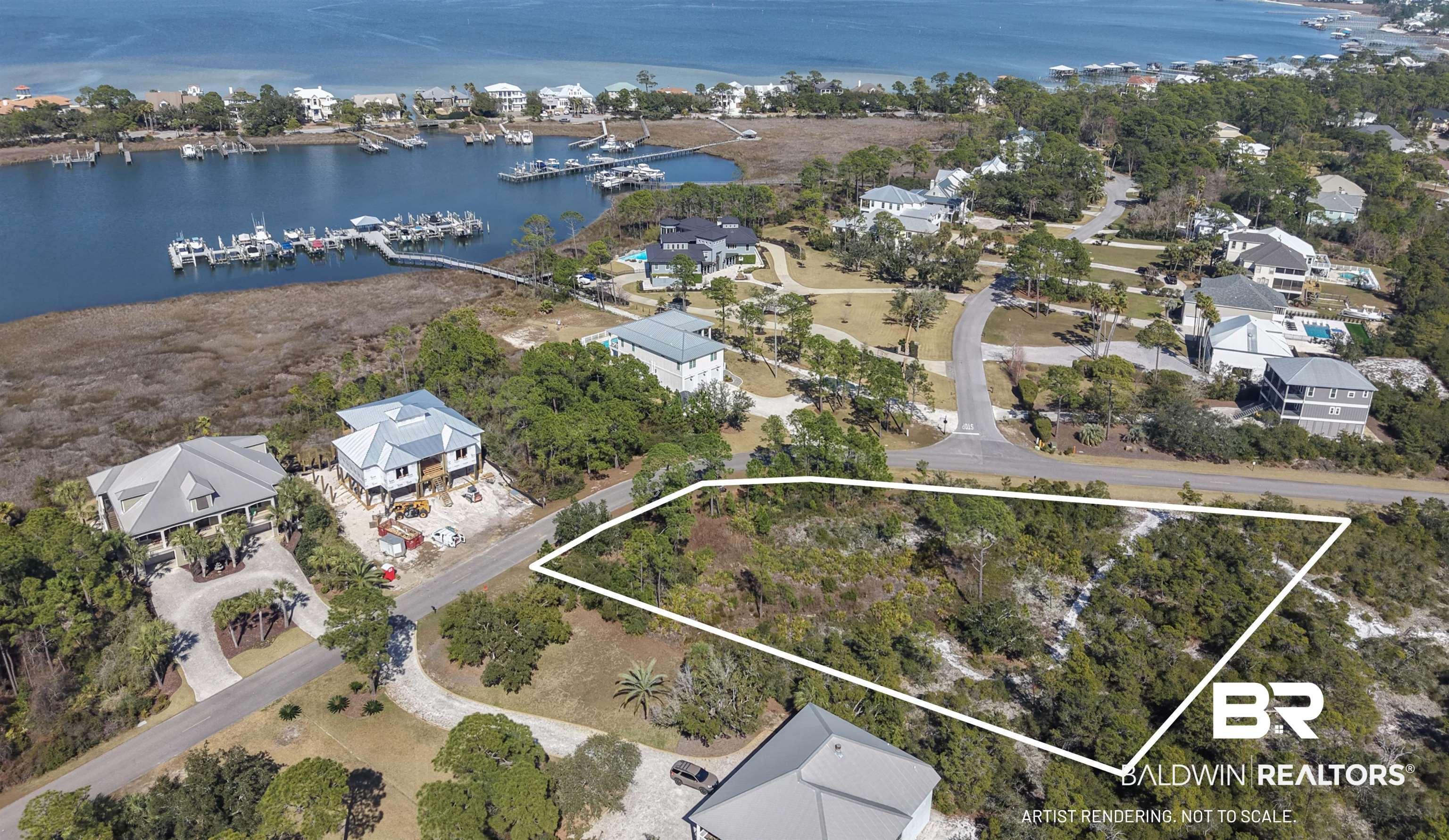 Image 1: Aerial view of residential area featuring a large body of water and property parcel outlined