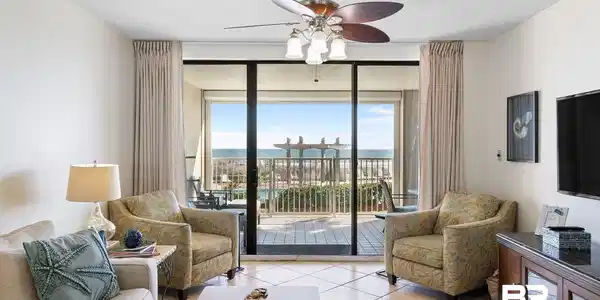 Image 2: Living room featuring ceiling fan, tile patterned flooring, a textured ceiling, and floor to ceiling windows