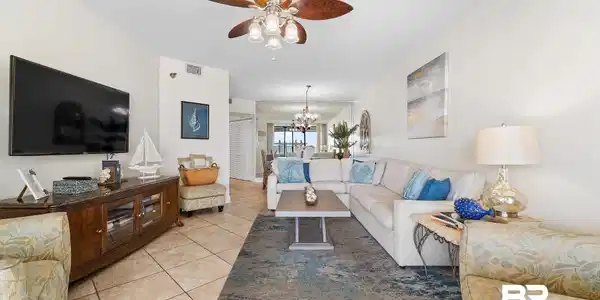 Image 3: Living area with hanging lights, a ceiling fan, light tile patterned floors, and a textured ceiling