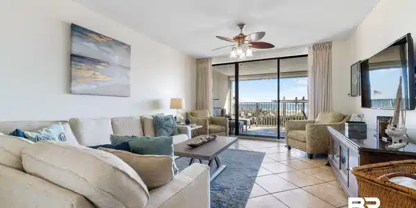 Image 4: Living area featuring floor to ceiling windows, a textured ceiling, ceiling fan, and light tile patterned floors