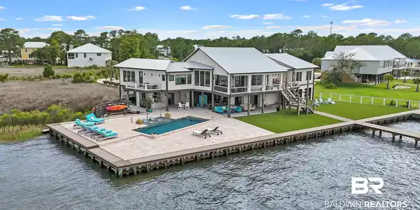 Image 4: Waterfront residence featuring a private pool and expansive paved patio