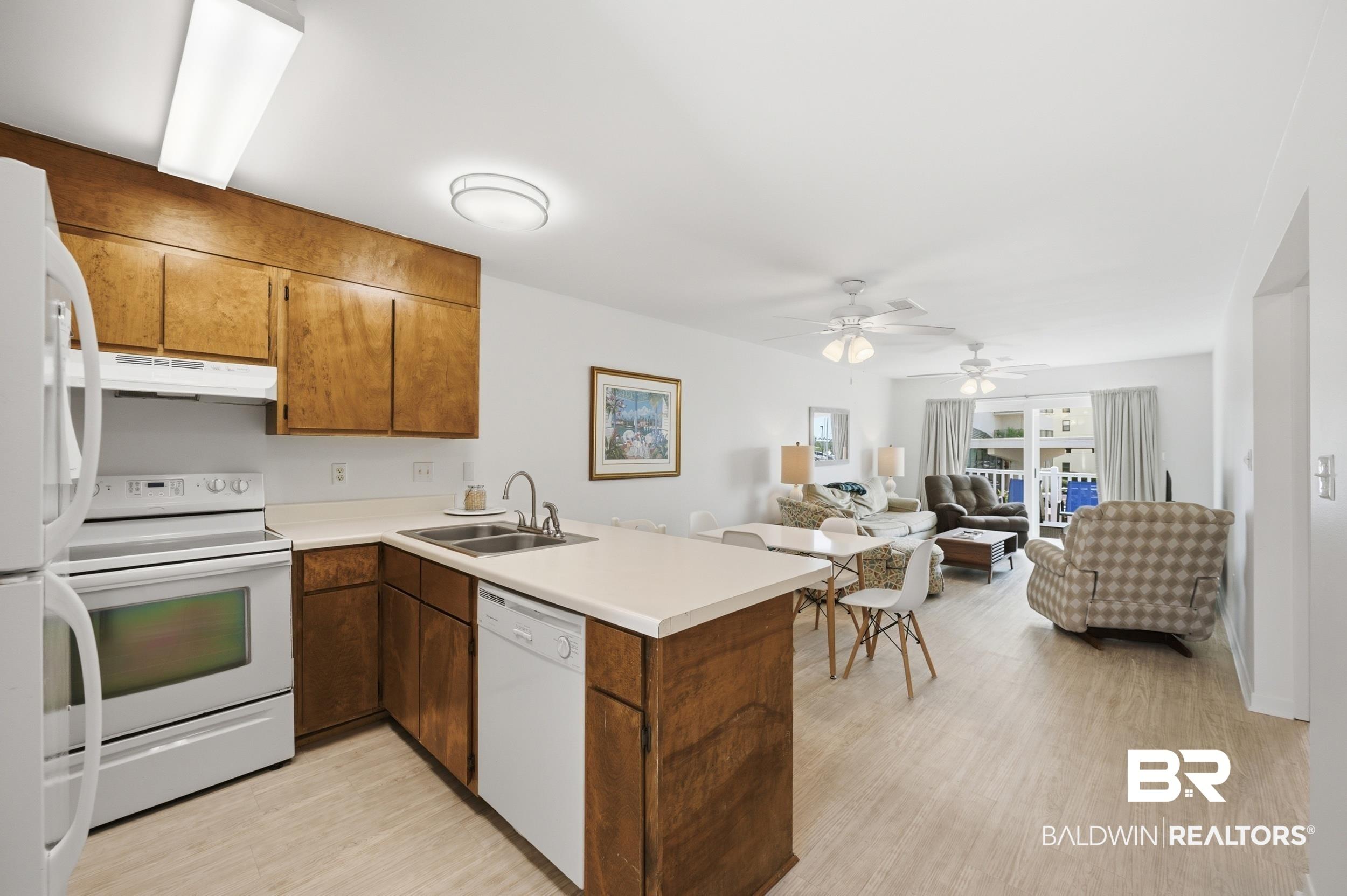 Image 2: Open-concept living area with wood-finish flooring