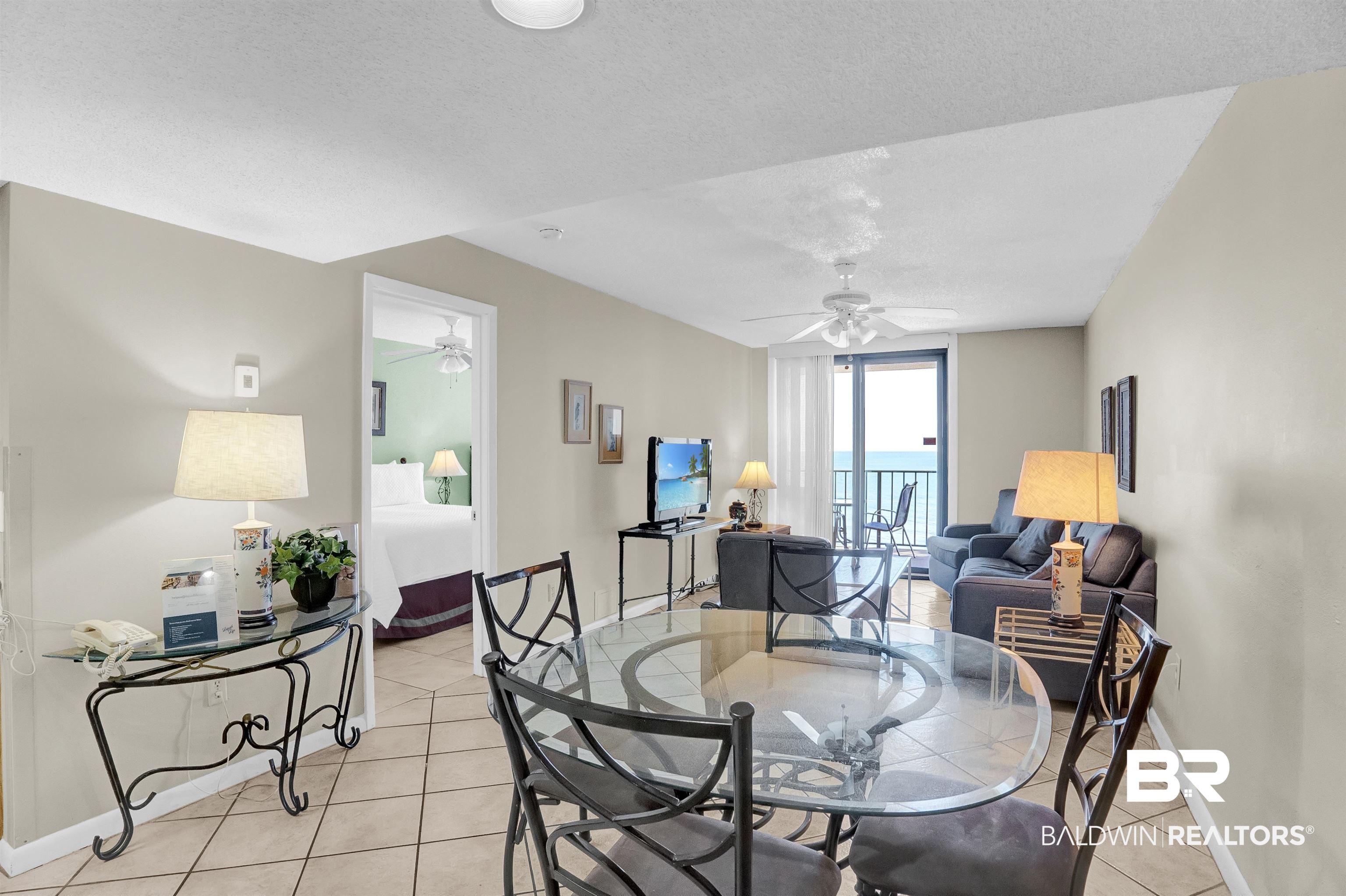 Image 4: Dining area with light tile patterned floors, baseboards, a textured ceiling, and ceiling fan