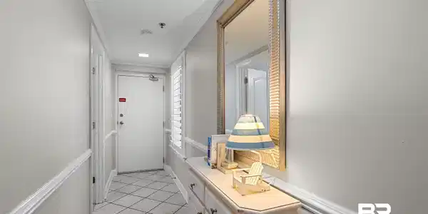Image 4: Entry hallway featuring diagonal tile flooring, white baseboards, and chair rail molding