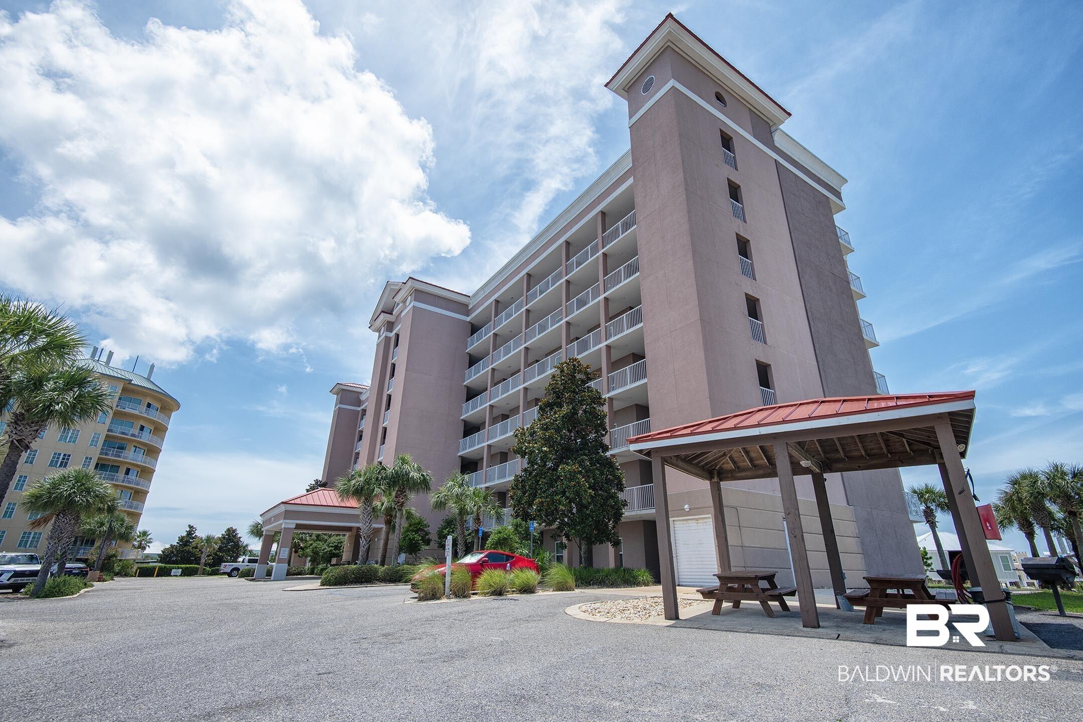 Image 2: Multi-story building featuring numerous private balconies with white railings