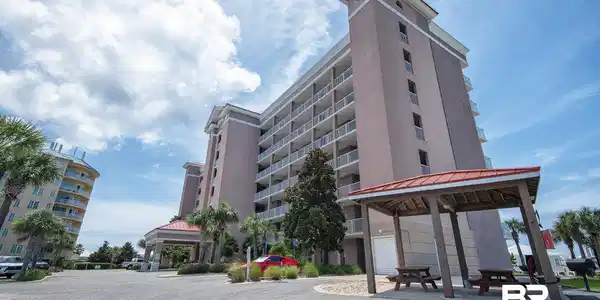 Image 2: Multi-story building featuring numerous private balconies with white railings