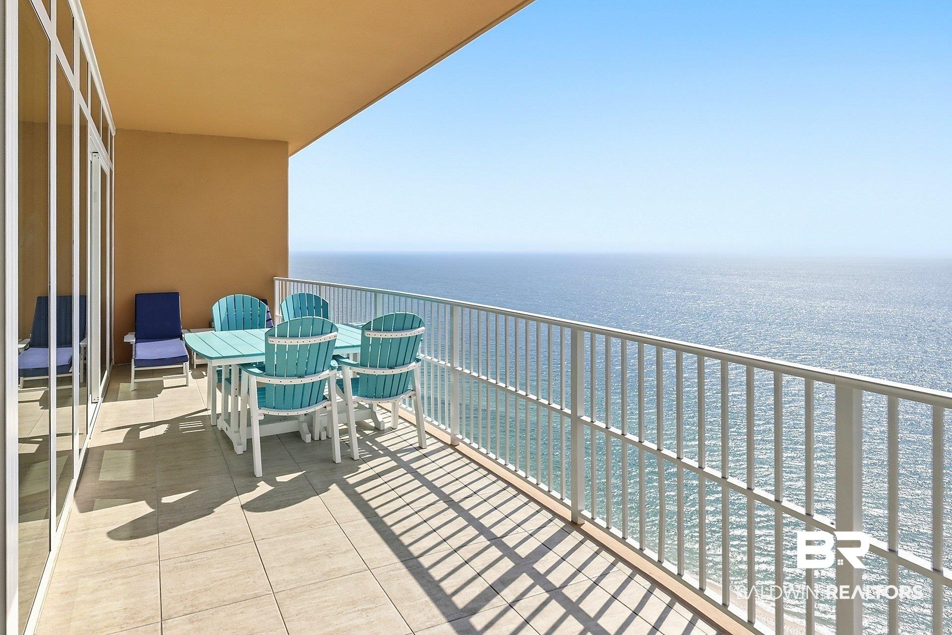 Image 3: Balcony featuring outdoor dining space and a water view