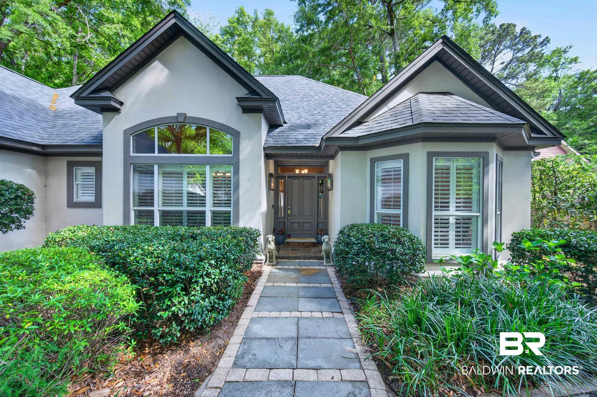 Image 1: Entrance to property with stucco siding and a shingled roof