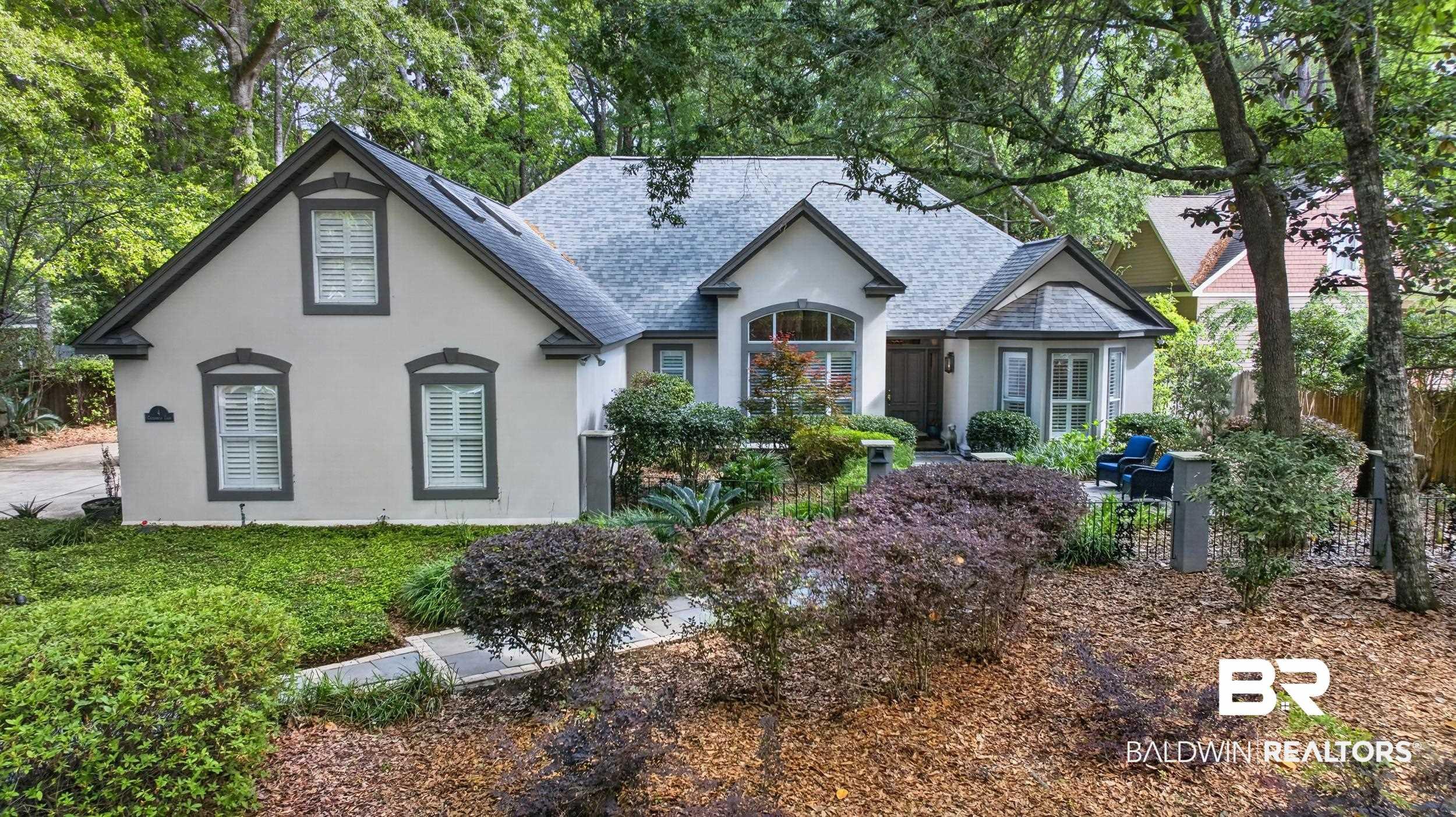 Image 2: View of front of home featuring stucco siding and a shingled roof