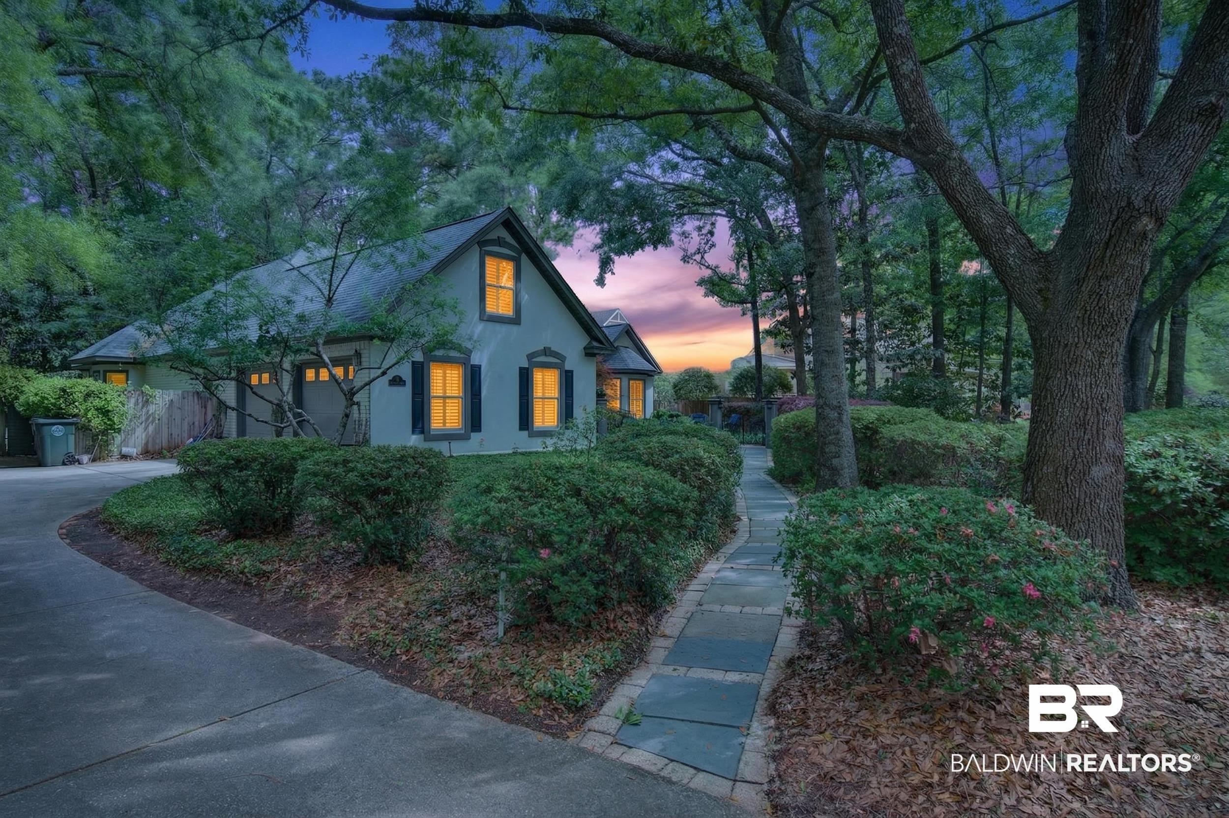 Image 3: View of front of house with stucco siding, a garage, a shingled roof, and concrete driveway