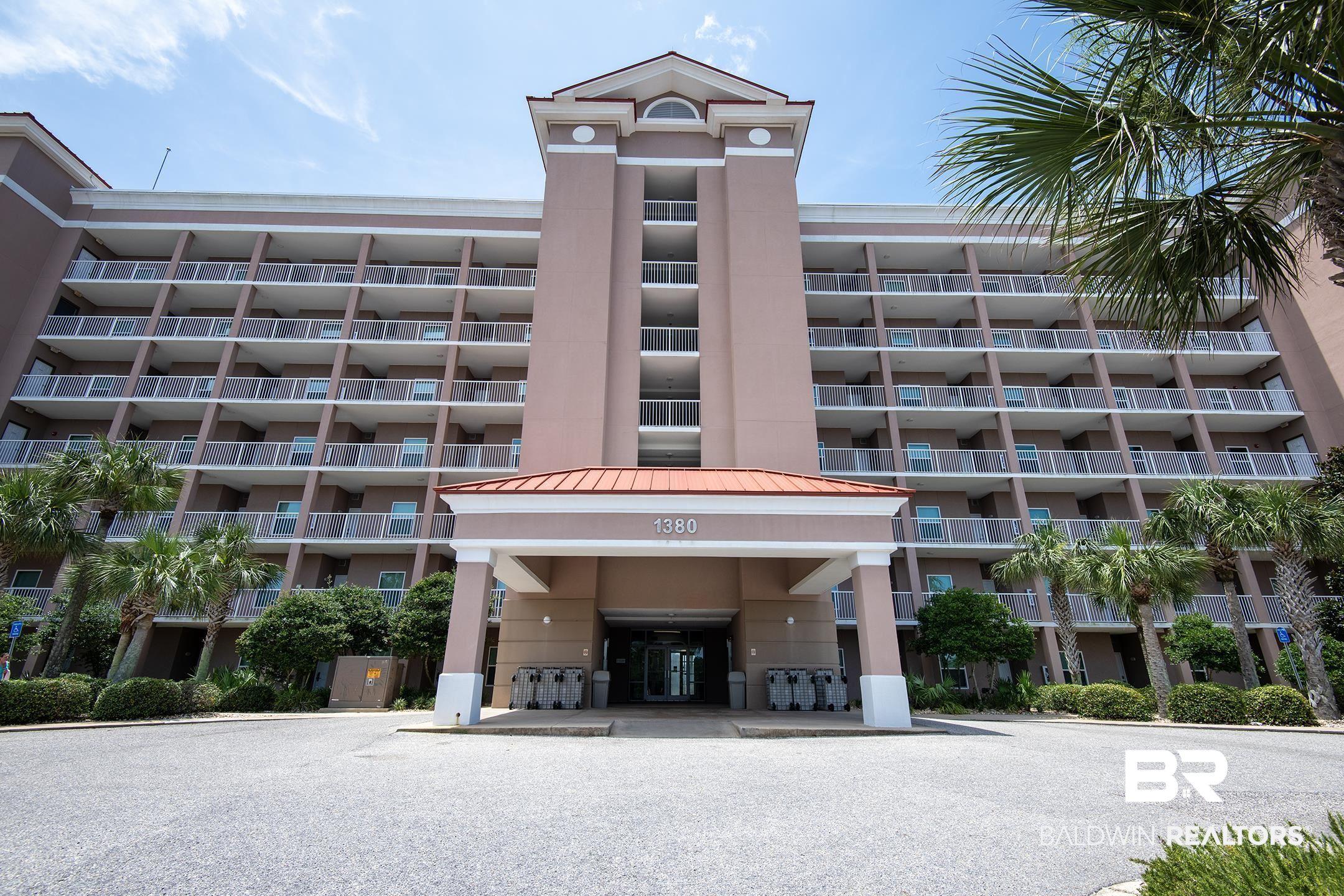 Image 4: Multi-story residential building featuring a prominent central entrance and numerous private balconies