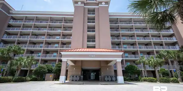 Image 4: Multi-story residential building featuring a prominent central entrance and numerous private balconies