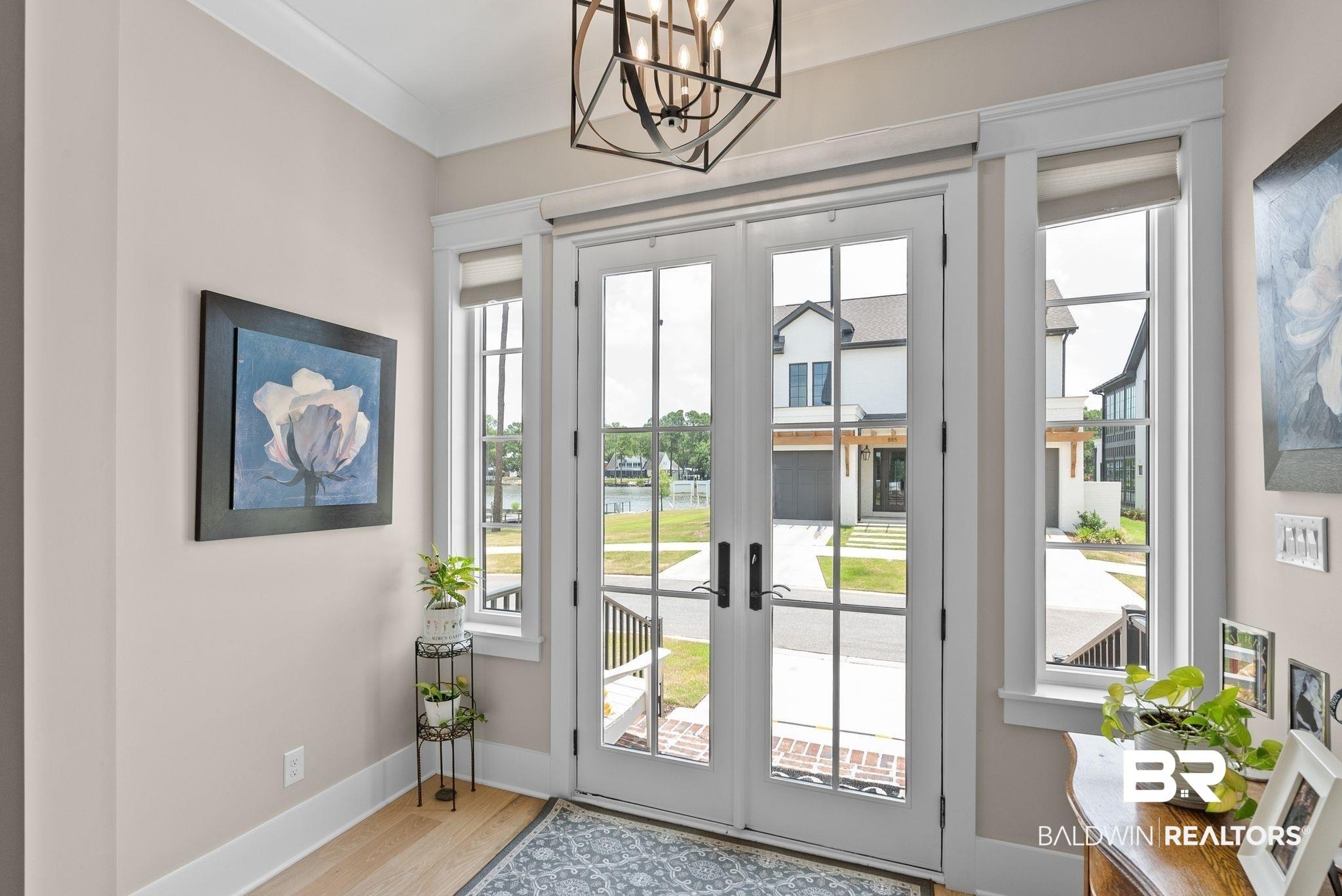 Image 4: Entryway featuring a double French door with divided lites, framing exterior views