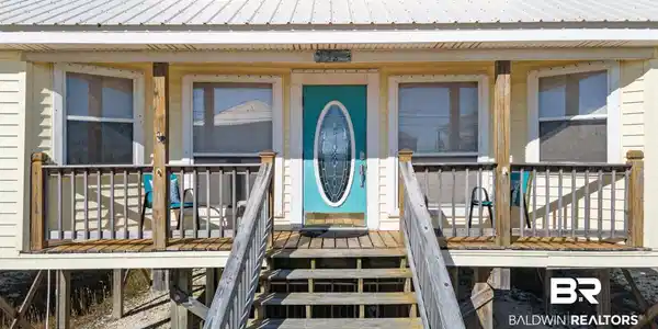 Image 3: Doorway to property featuring a metal roof