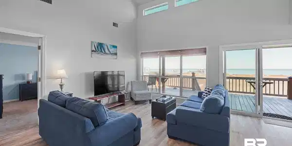 Image 4: Living area with light wood-style floors and high vaulted ceiling